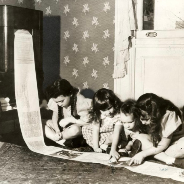 Children read a wirelessly transmitted newspaper